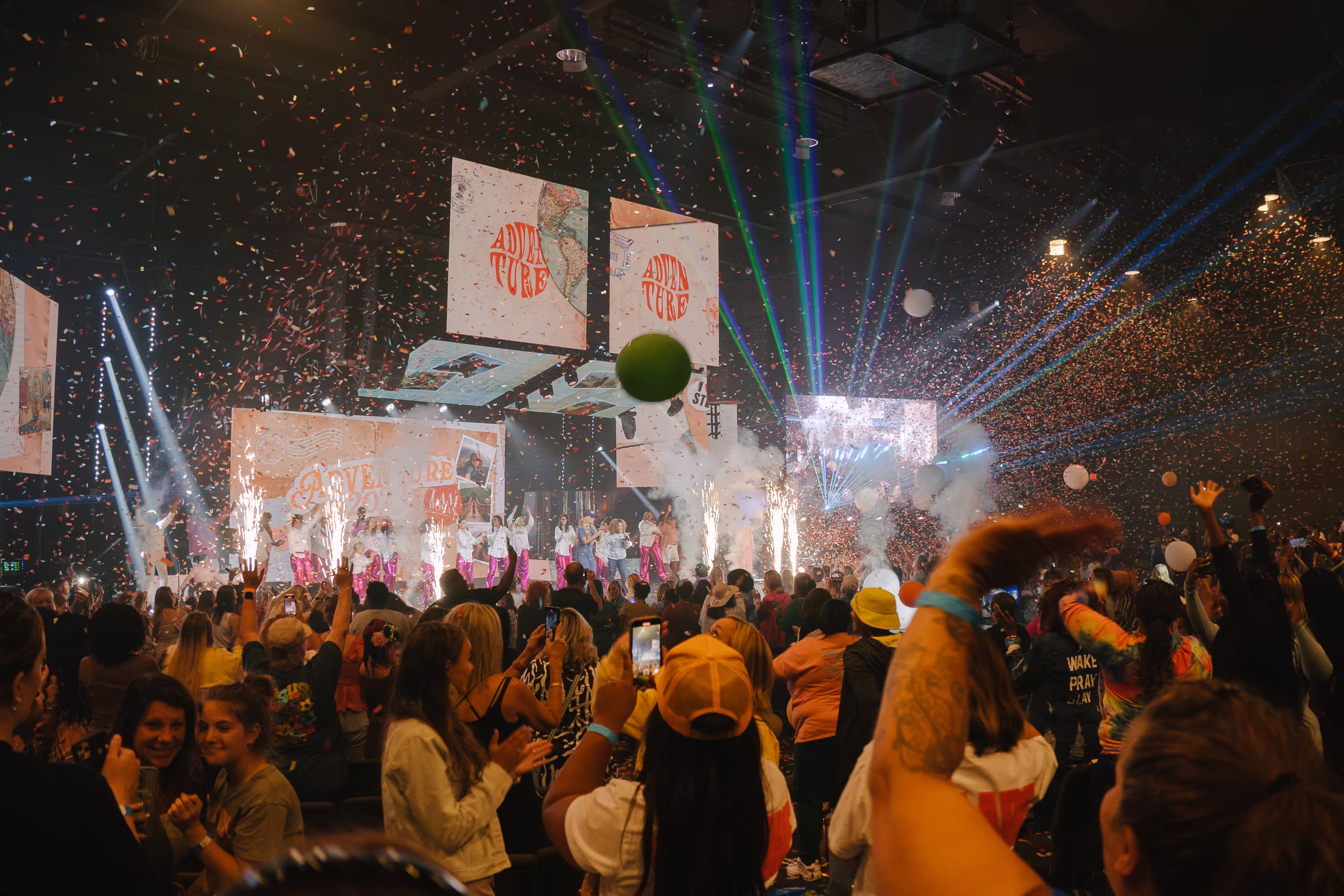 Confetti falling over a packed arena at the I Am Woman Conference